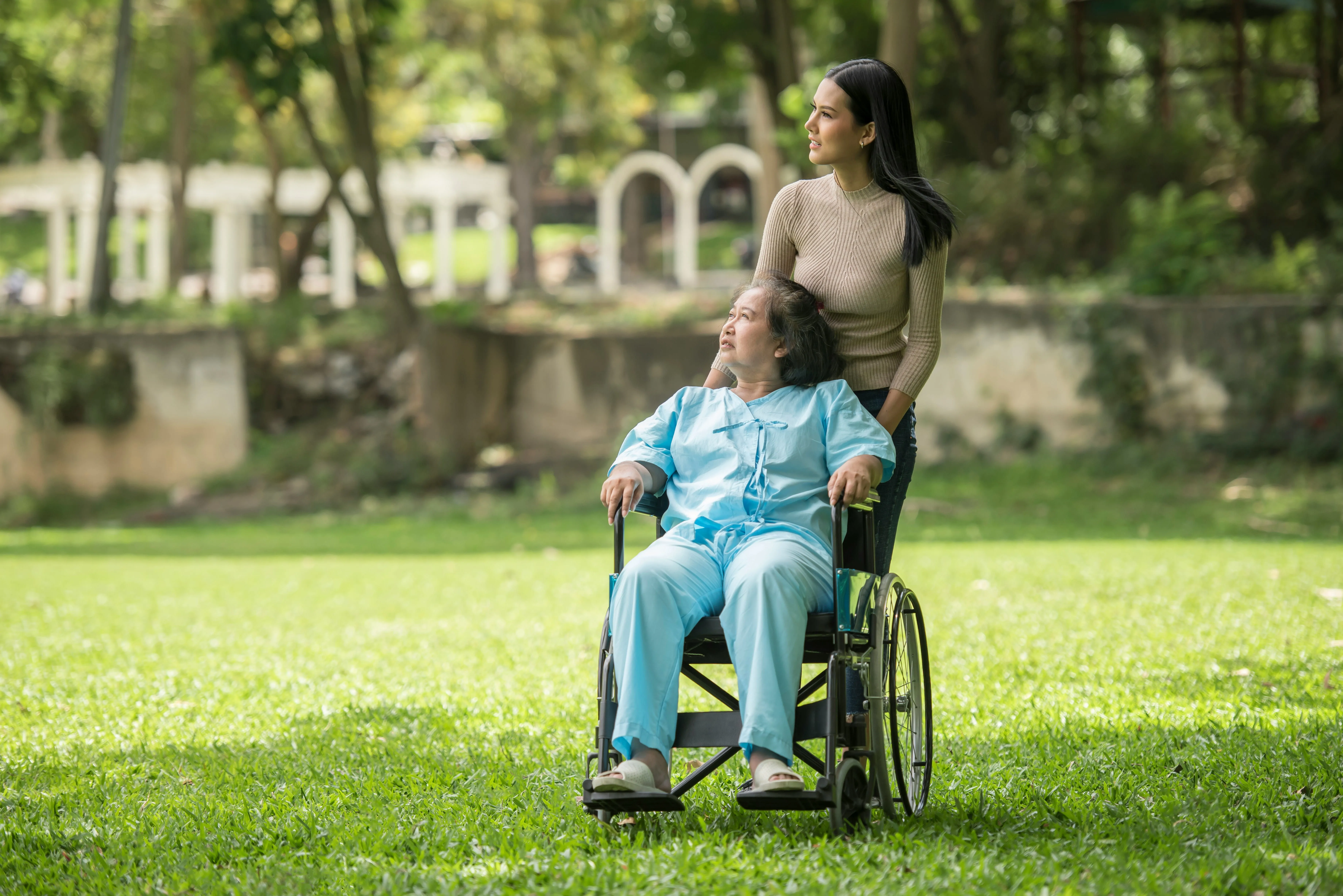 A carer sitting with an older adult, sharing a calm, attentive moment together